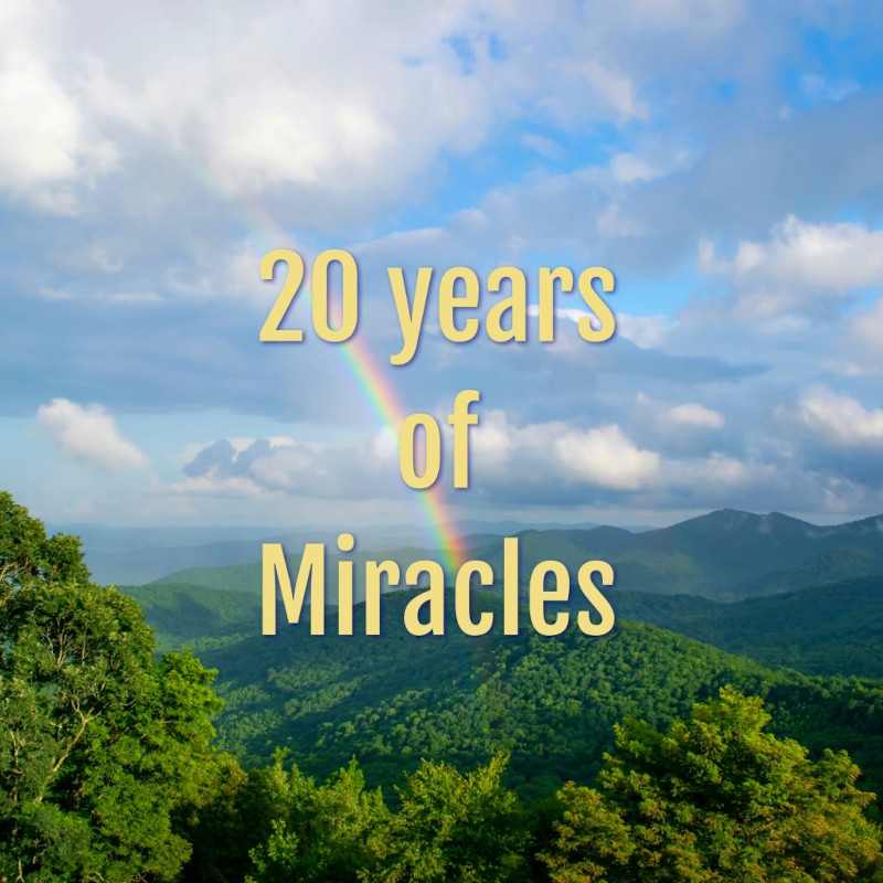 20 Years of Miracles above rainbow and green mountains